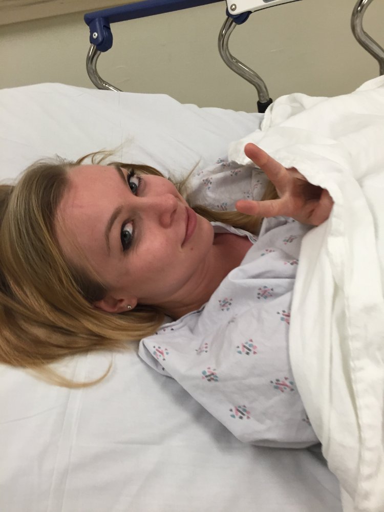 Heather recovering after surgery, peace sign